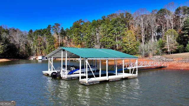 a view of a lake with house swimming pool and outdoor space