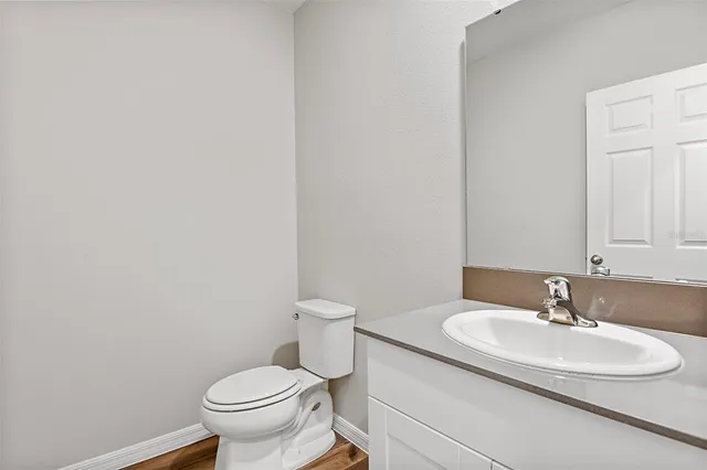 a bathroom with a sink toilet and a mirror