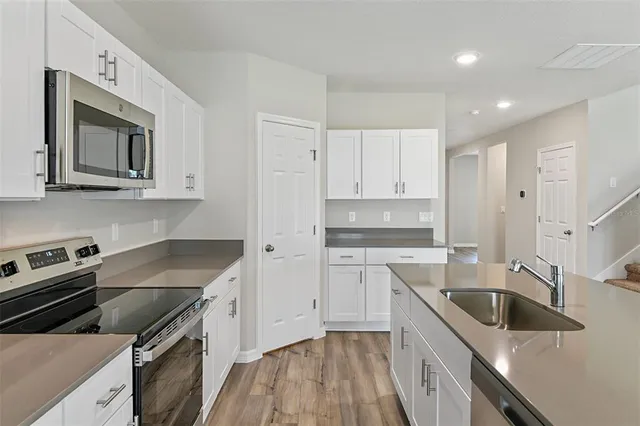 a kitchen that has a sink and a stove