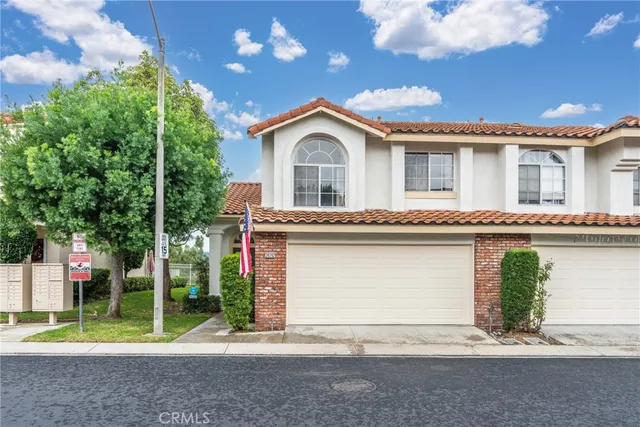 a front view of a house with a garden and plants