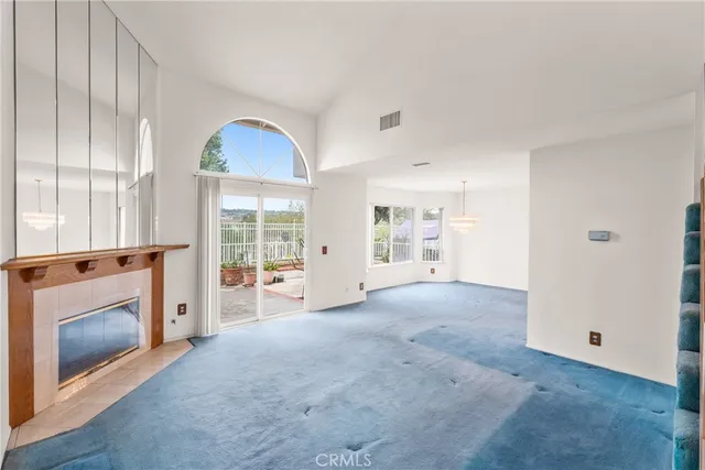 a view of a livingroom with an empty space and a fireplace