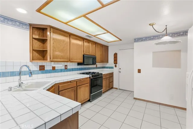 a kitchen with a sink appliances and cabinets