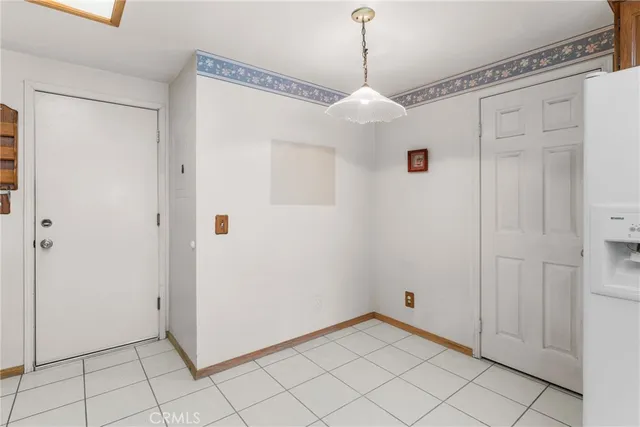 a view of a chandelier fan and entryway