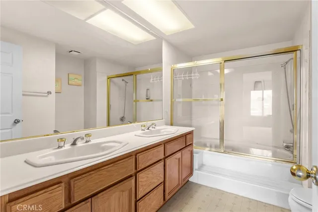 a spacious bathroom with a granite countertop sink mirror and a bathtub