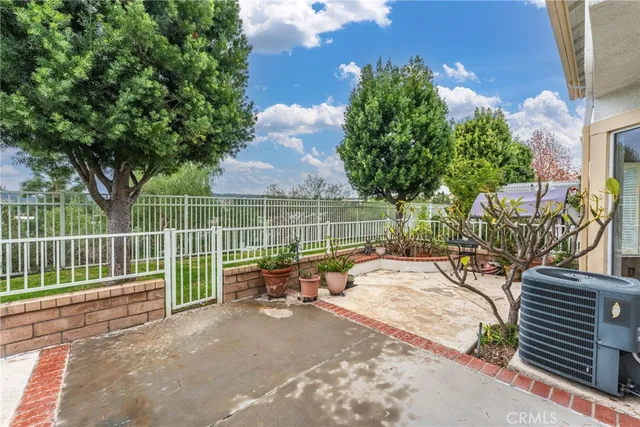 a view of a park with iron fence