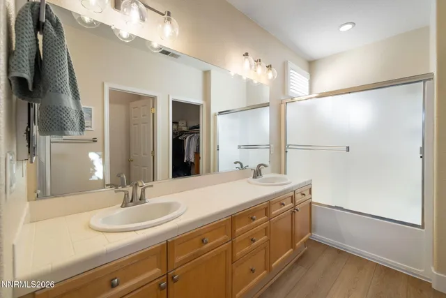 a bathroom with a sink double vanity and a mirror