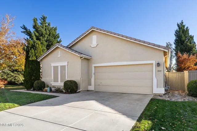 a view of a white house with a yard