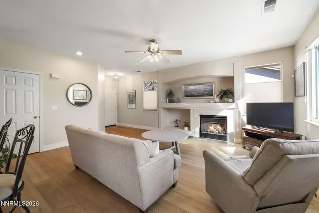 a living room with furniture a fireplace and a flat screen tv
