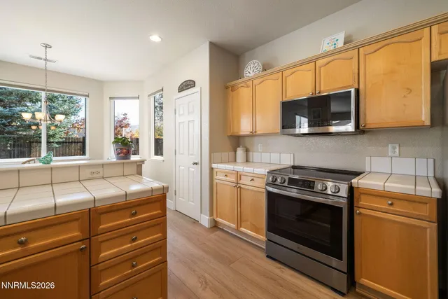 a kitchen with a stove a sink and a microwave