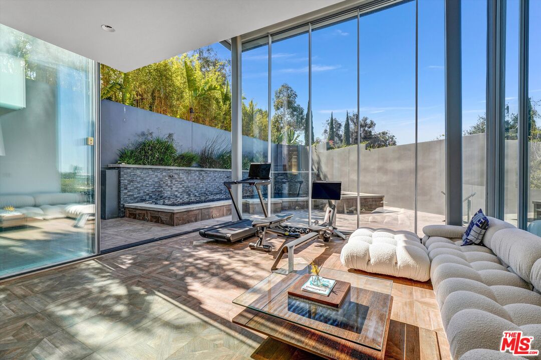 9400 Readcrest Drive Beverly Hills, CA 90210 - Photo 11 of 33 a living room with patio furniture and a floor to ceiling window