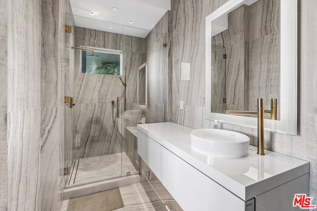 9400 Readcrest Drive Beverly Hills, CA 90210 - Photo 20 of 33 a bathroom with a tub sink and mirror