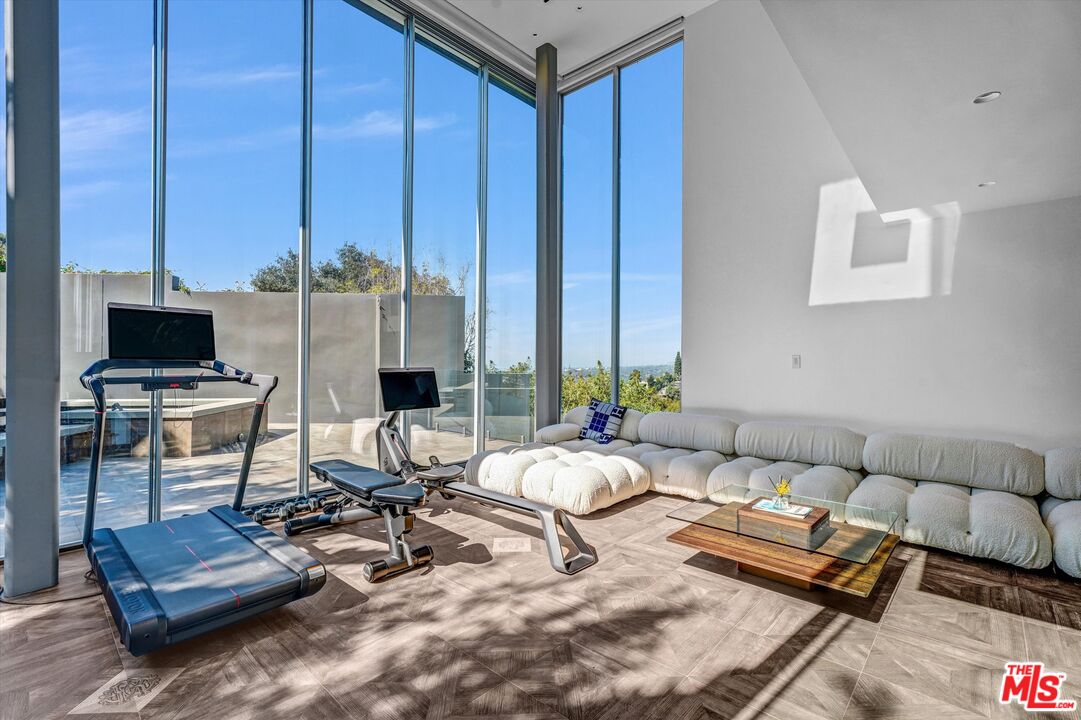 9400 Readcrest Drive Beverly Hills, CA 90210 - Photo 10 of 33 a living room with furniture a flat screen tv and a window