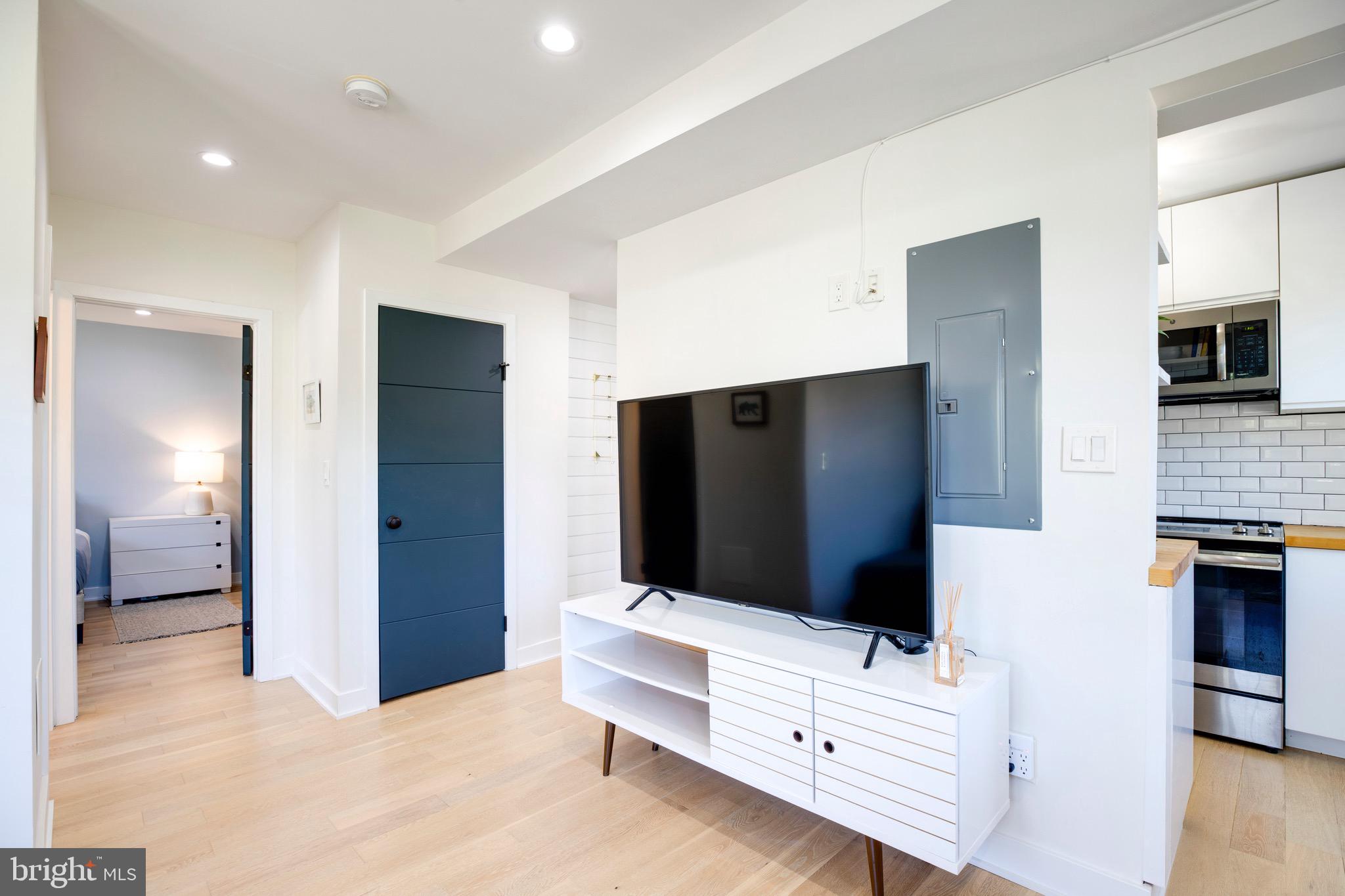 2625 3rd Street Northeast, Unit 203 Washington, DC 20002 - Photo 14 of 25 a living room with flat screen tv and gym equipment