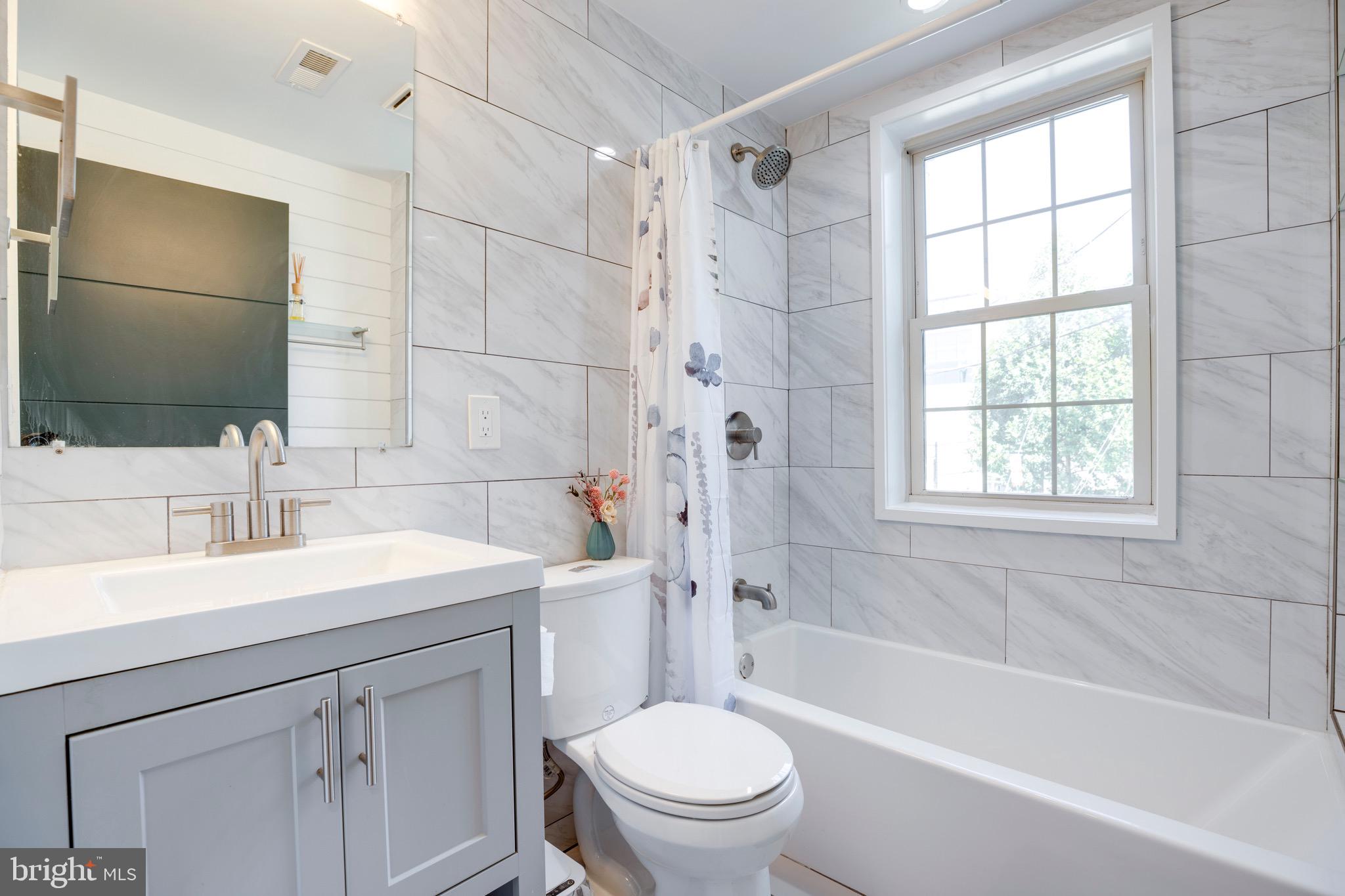 2625 3rd Street Northeast, Unit 203 Washington, DC 20002 - Photo 15 of 25 a bathroom with a sink a toilet and shower