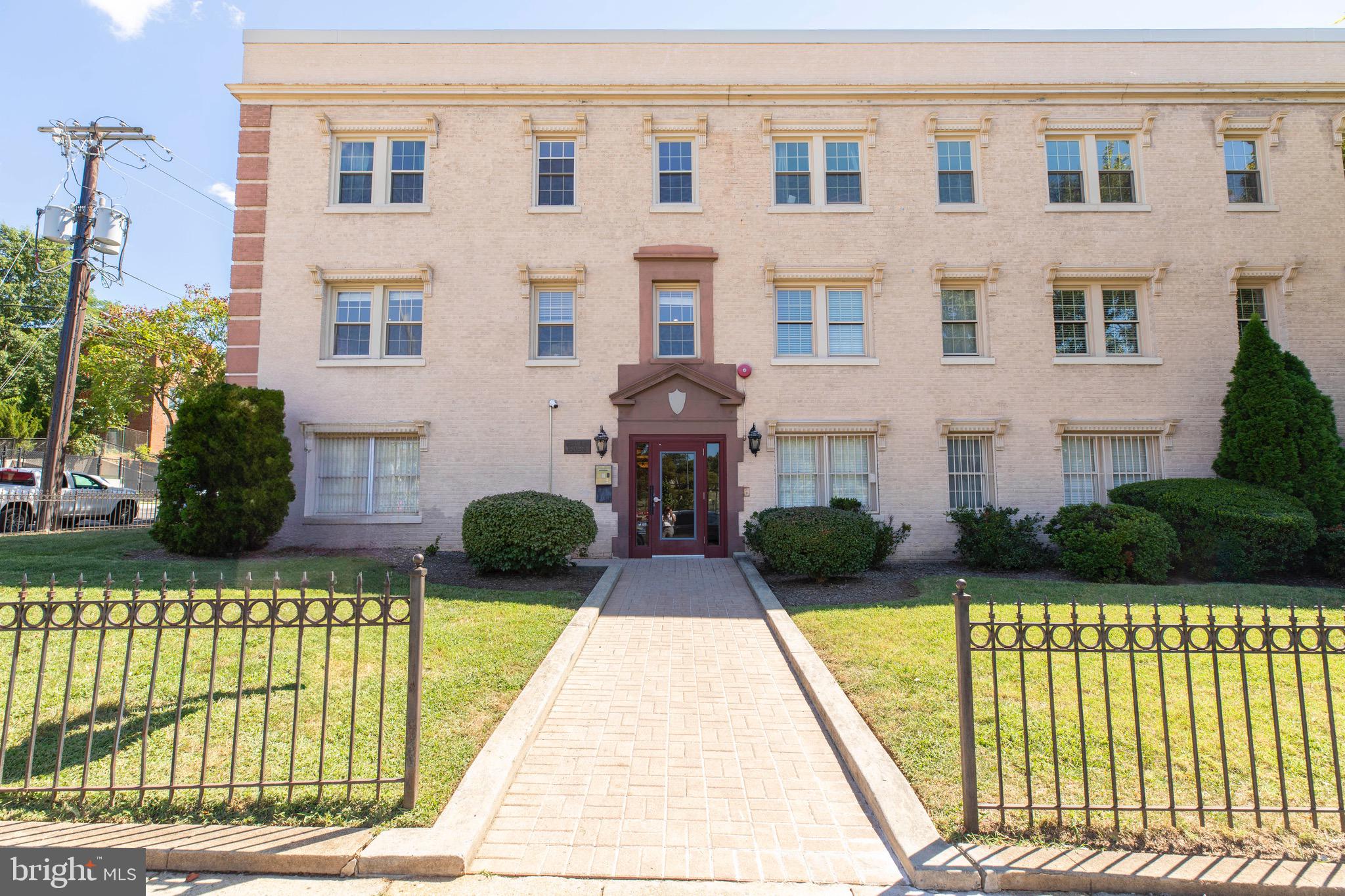 2625 3rd Street Northeast, Unit 203 Washington, DC 20002 - Photo 20 of 25 a front view of a brick house with a yard