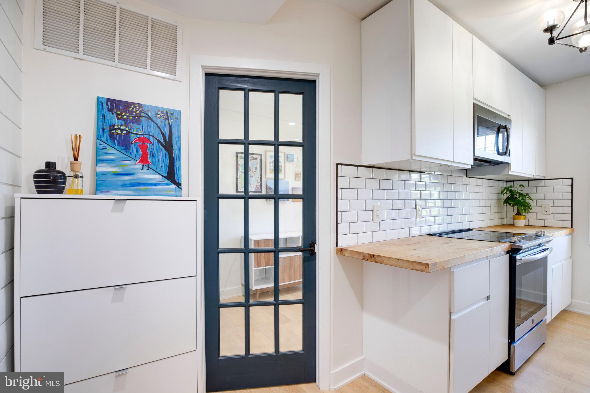 2625 3rd Street Northeast, Unit 203 Washington, DC 20002 - Photo 6 of 25 a kitchen with stainless steel appliances granite countertop a refrigerator and a stove
