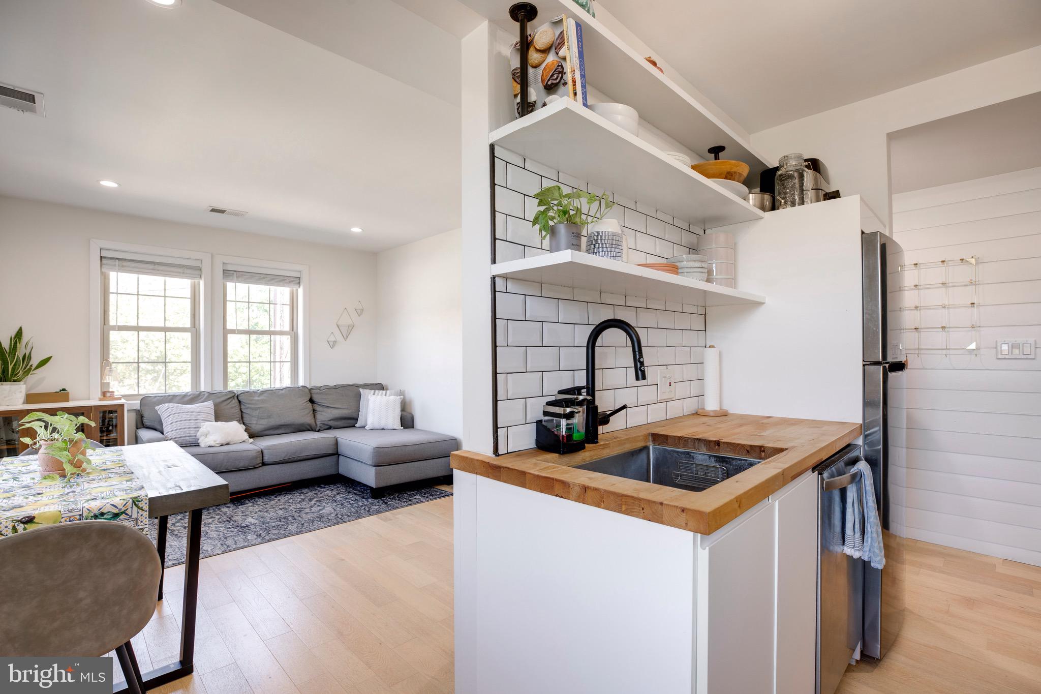 2625 3rd Street Northeast, Unit 203 Washington, DC 20002 - Photo 7 of 25 a living room with furniture and a fireplace