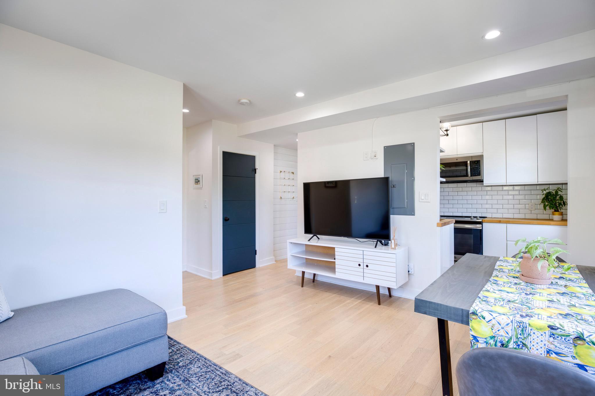 2625 3rd Street Northeast, Unit 203 Washington, DC 20002 - Photo 9 of 25 a living room with furniture and a flat screen tv