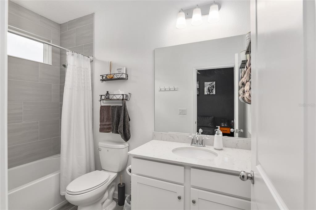 5688 Southwest 92nd Place Ocala, FL 34476 - Photo 42 of 54 a bathroom with a sink a toilet and shower