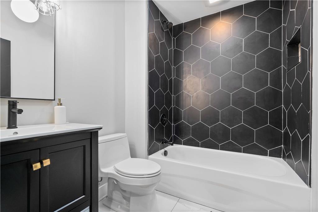 710 Cedar Avenue Pittsburgh, PA 15212 - Photo 15 of 25 a bathroom with a bathtub a sink a toilet and a mirror