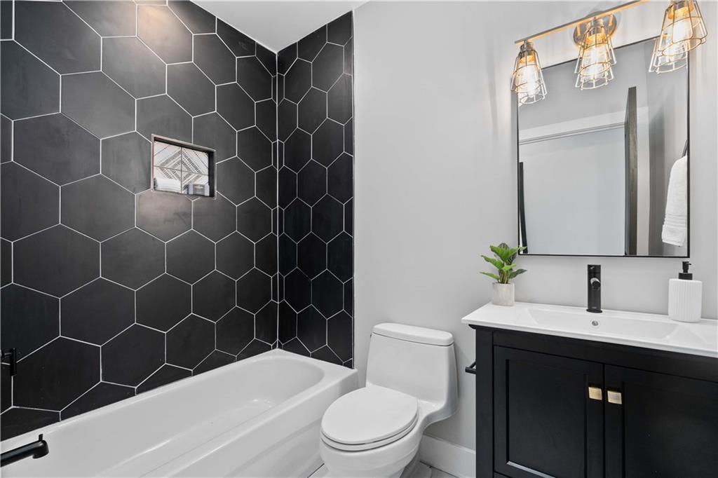 710 Cedar Avenue Pittsburgh, PA 15212 - Photo 16 of 25 a bathroom with a sink a toilet and shower