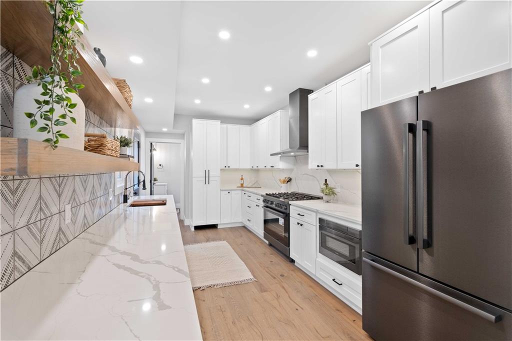 710 Cedar Avenue Pittsburgh, PA 15212 - Photo 20 of 25 a kitchen with stainless steel appliances a refrigerator sink and stove