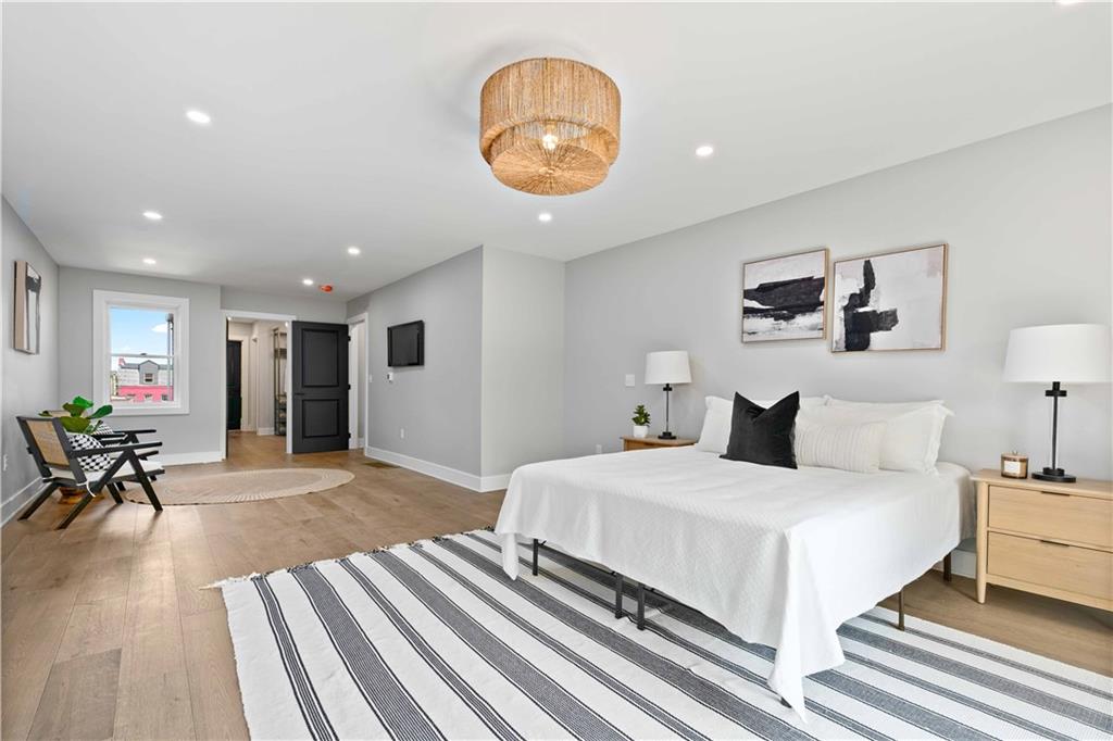 710 Cedar Avenue Pittsburgh, PA 15212 - Photo 24 of 25 a bedroom with a bed and a chandelier