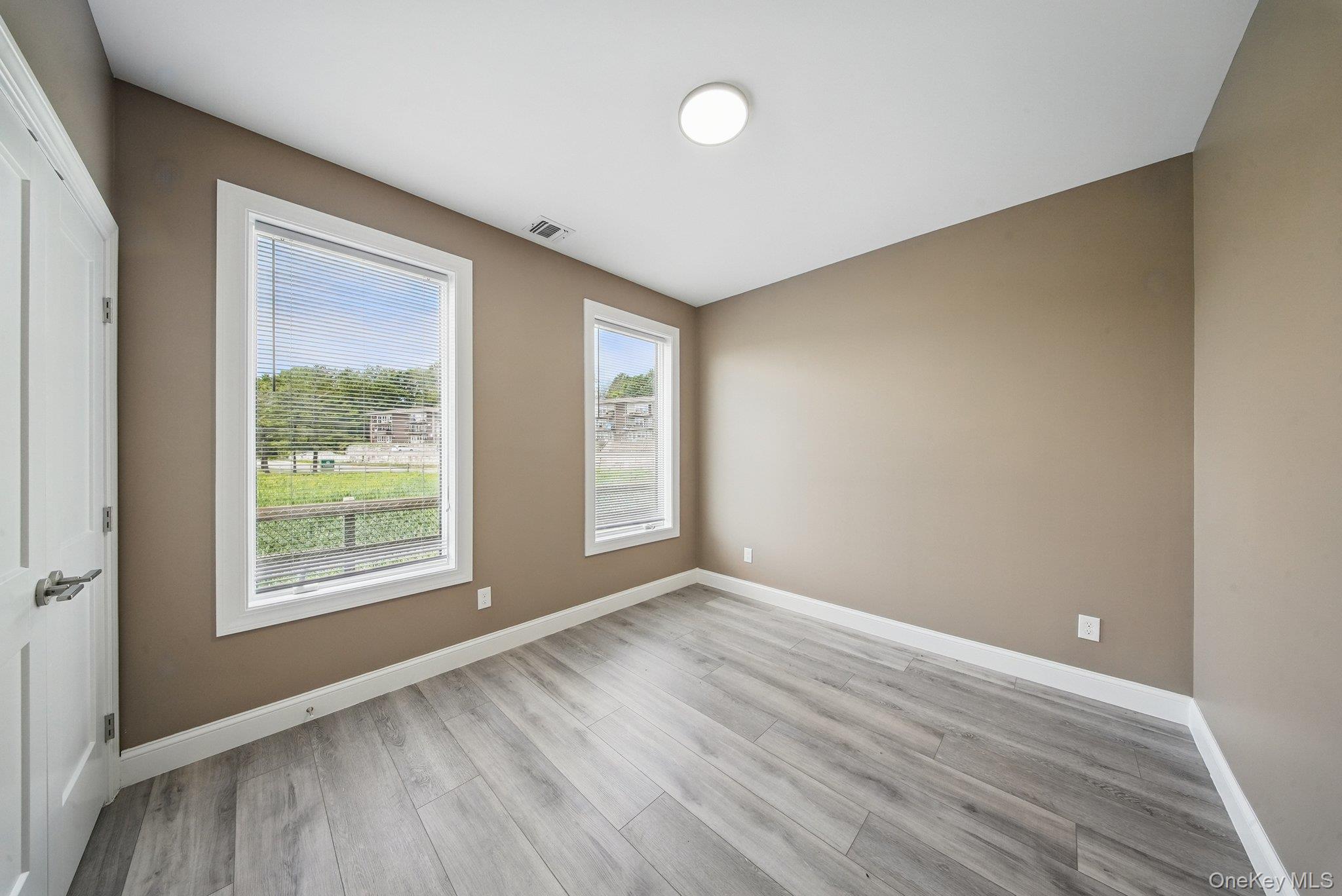 6 Giada Lane, Unit 6 Middletown, NY 10940 - Photo 16 of 29 an empty room with wooden floor and windows