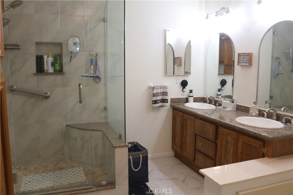 9453 Sharon Way Calimesa, CA 92320 - Photo 13 of 15 a bathroom with a double vanity sink mirror and shower