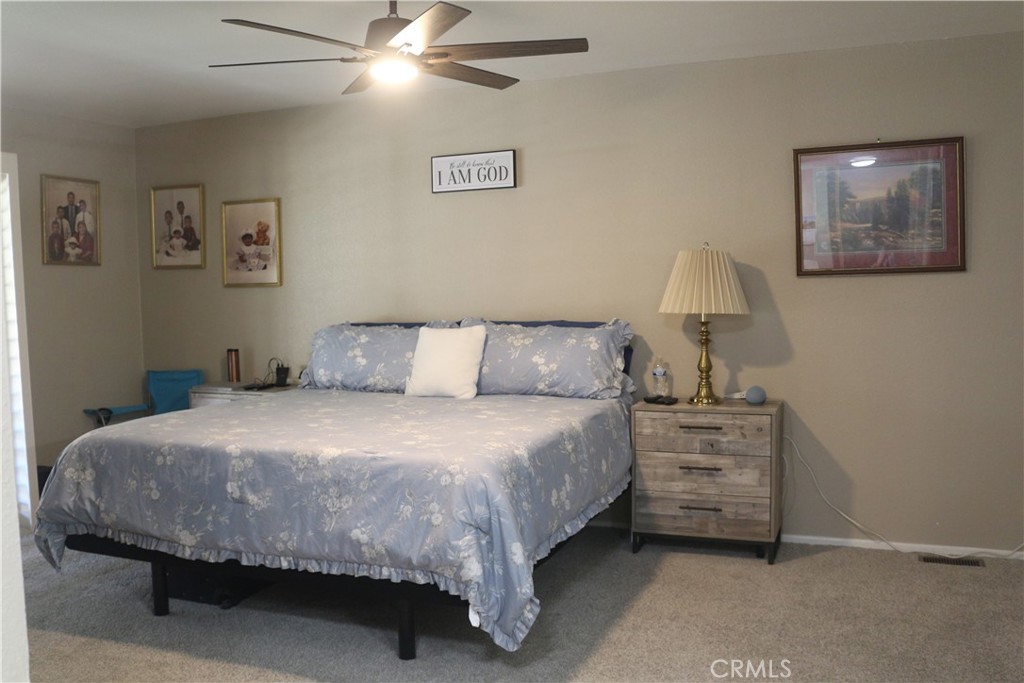 9453 Sharon Way Calimesa, CA 92320 - Photo 14 of 15 a bedroom with a bed and wall painting