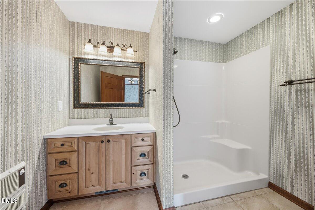 13616 New Light Road Raleigh, NC 27614 - Photo 17 of 60 a bathroom with a double vanity sink mirror and bathtub
