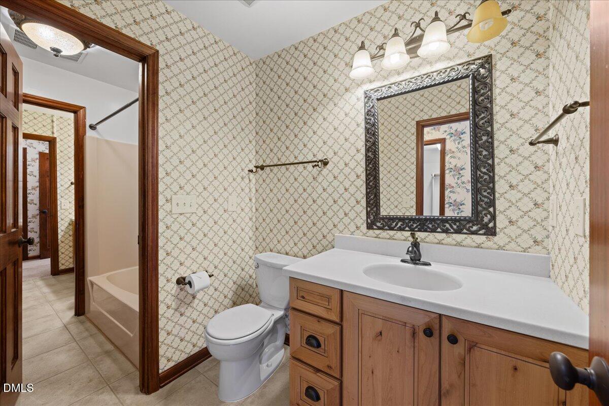 13616 New Light Road Raleigh, NC 27614 - Photo 26 of 60 a bathroom with a sink a toilet and shower