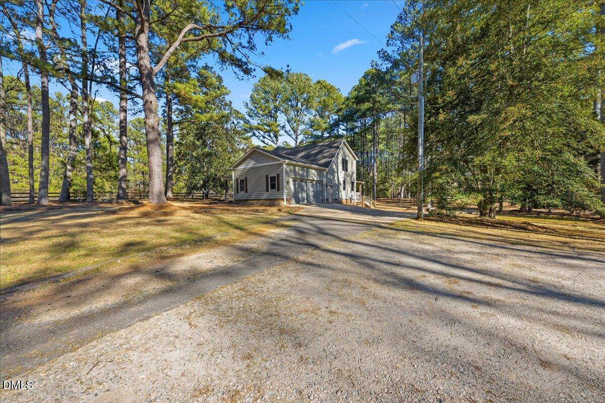 13616 New Light Road Raleigh, NC 27614 - Photo 3 of 60 a front view of a house with a garden