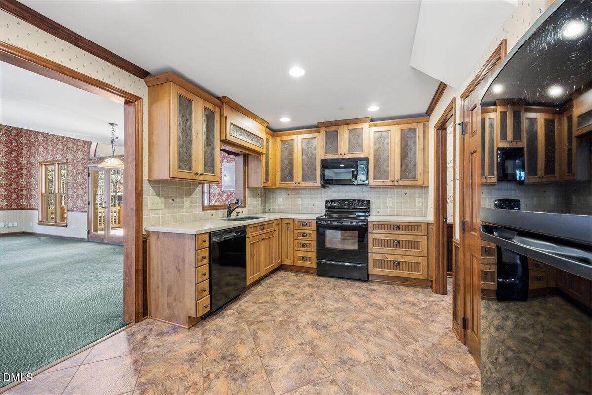 13616 New Light Road Raleigh, NC 27614 - Photo 9 of 60 a kitchen with stainless steel appliances kitchen island granite countertop a refrigerator and a stove top oven