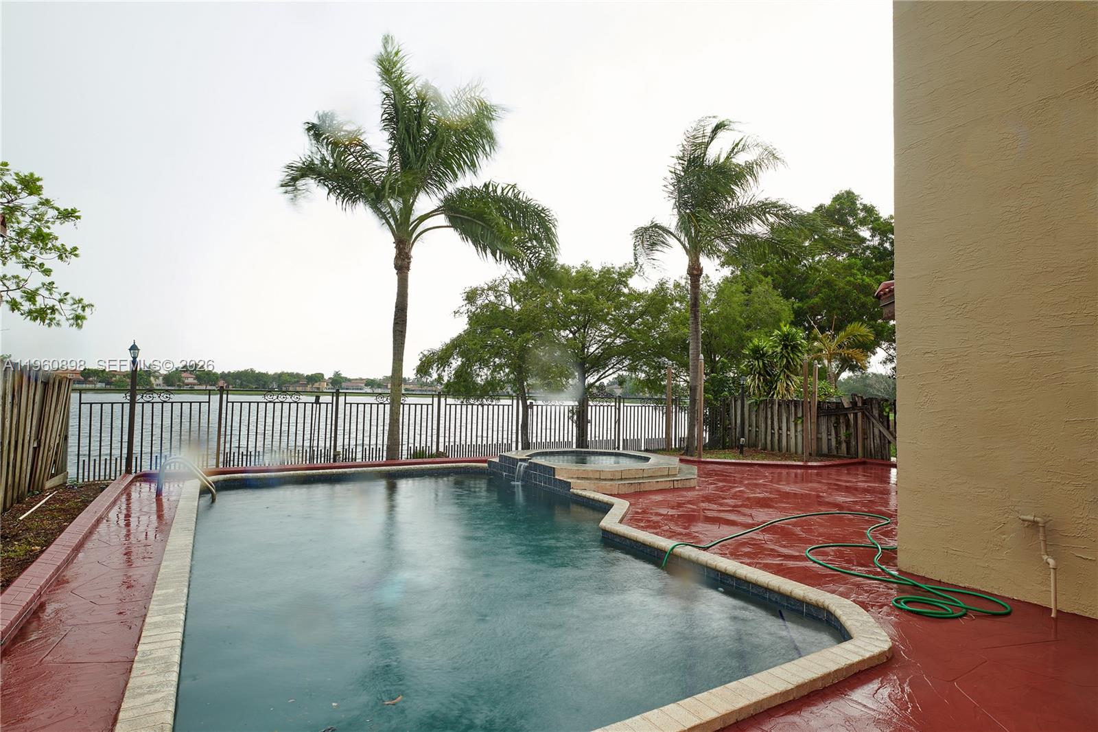 20030 Northwest 83rd Court Hialeah, FL 33015 - Photo 25 of 33 a view of a backyard with a wooden fence