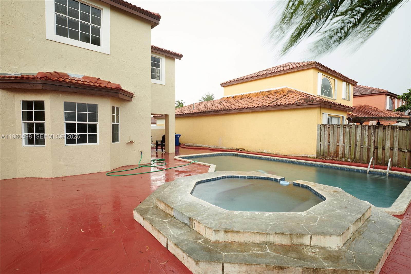 20030 Northwest 83rd Court Hialeah, FL 33015 - Photo 26 of 33 a view of a house with pool and chairs