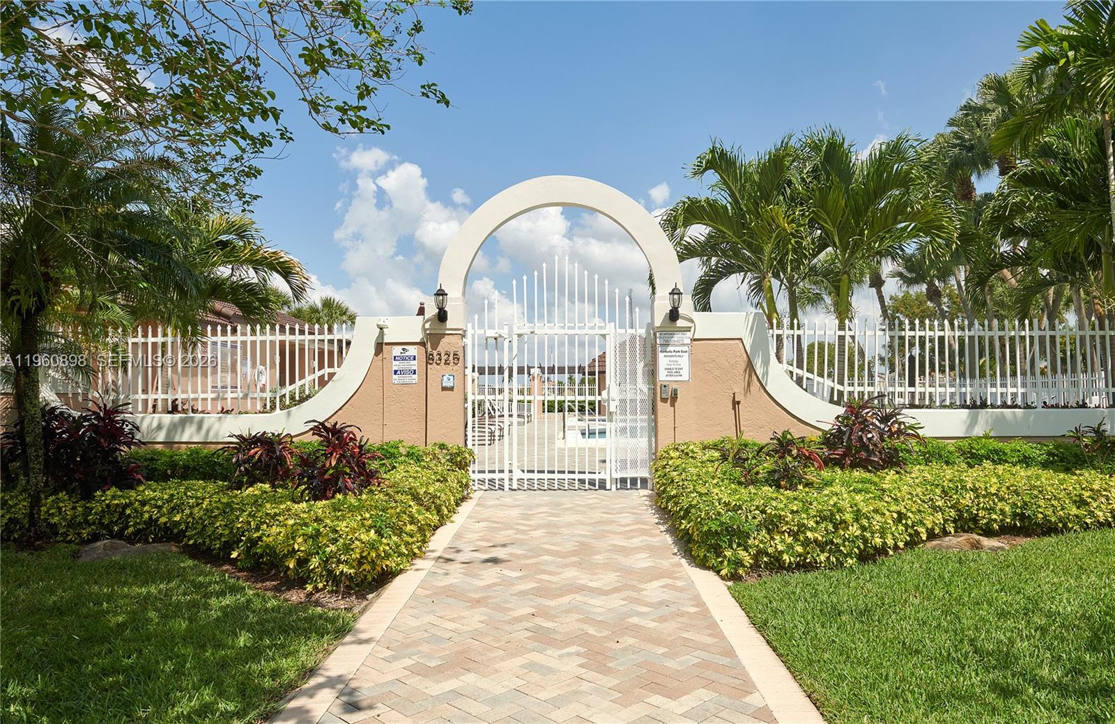 20030 Northwest 83rd Court Hialeah, FL 33015 - Photo 28 of 33 a front view of a house with a garden