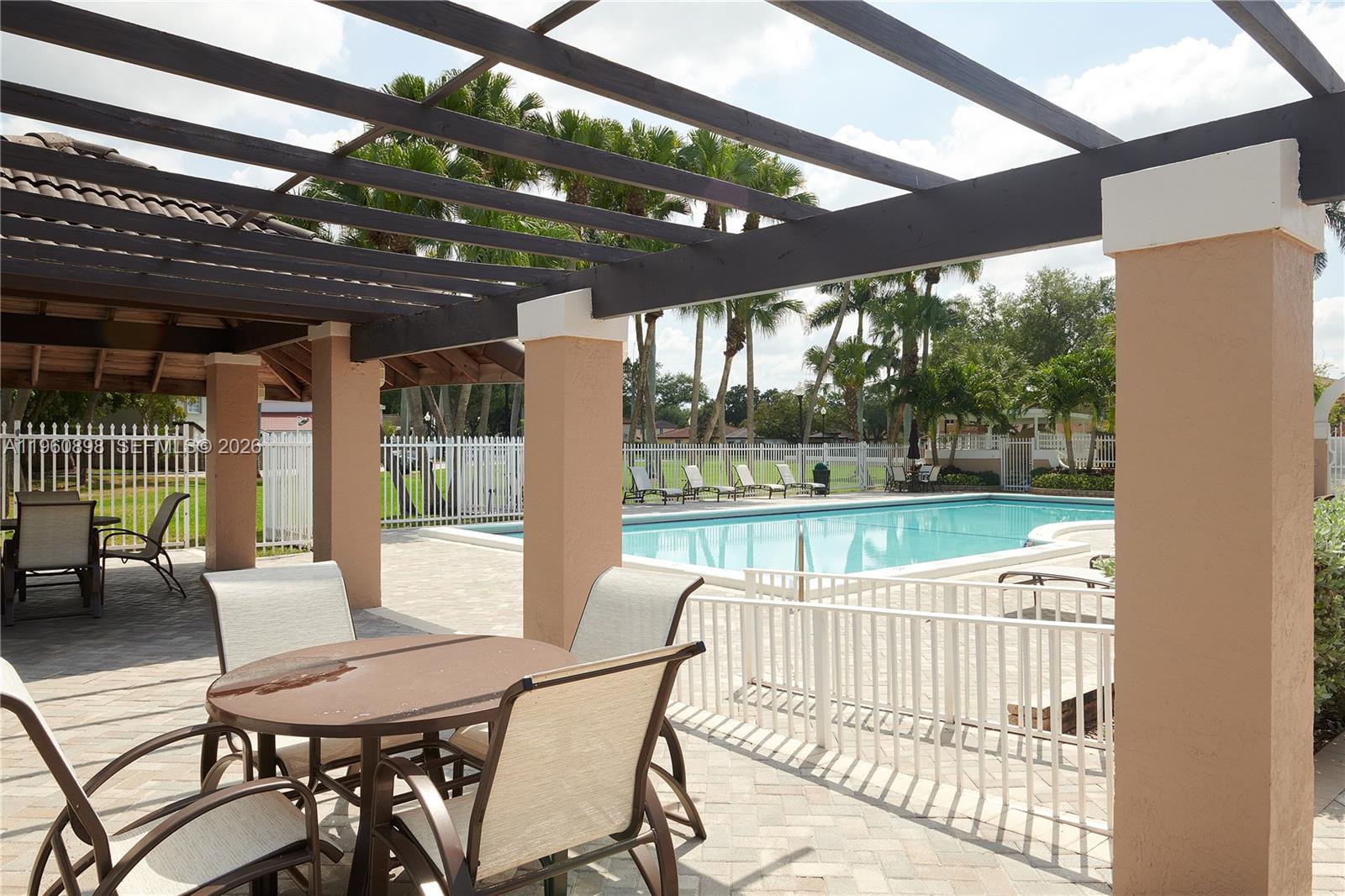 20030 Northwest 83rd Court Hialeah, FL 33015 - Photo 31 of 33 a view of a chair and tables in the patio