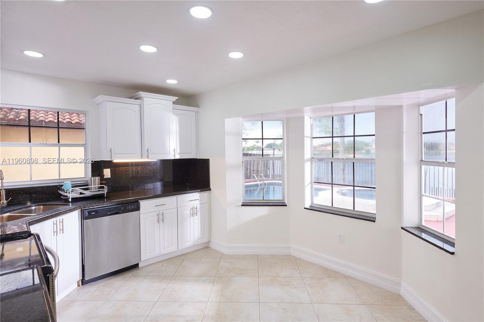 20030 Northwest 83rd Court Hialeah, FL 33015 - Photo 9 of 33 a kitchen with stainless steel appliances a stove a sink and a microwave