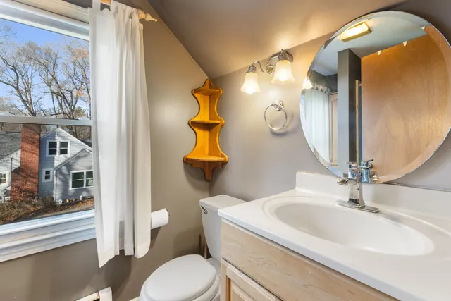 a bathroom with a toilet sink and mirror