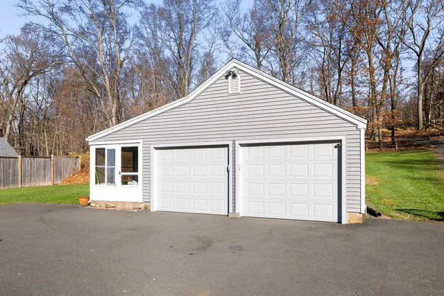 a view of a house with a yard and sitting area