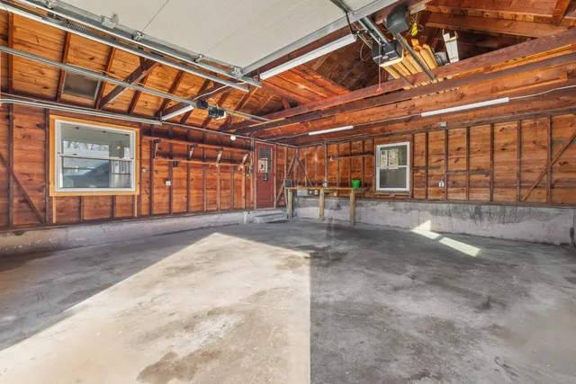 a view of an empty room with wooden floor and walls