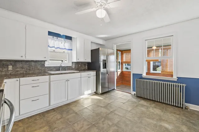 a kitchen with cabinets and window