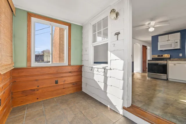 a kitchen with white cabinets and appliances