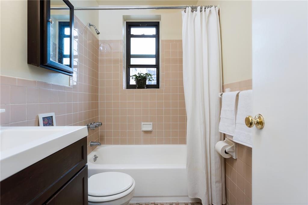 68 Stratford Road, Unit 7 Brooklyn, NY 11218 - Photo 5 of 13 a bathroom with a bathtub sink vanity mirror and toilet