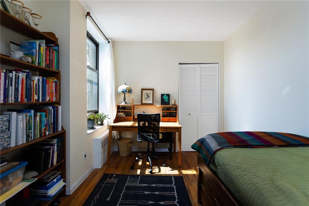 68 Stratford Road, Unit 7 Brooklyn, NY 11218 - Photo 10 of 13 a bedroom with a bed furniture and a book shelf