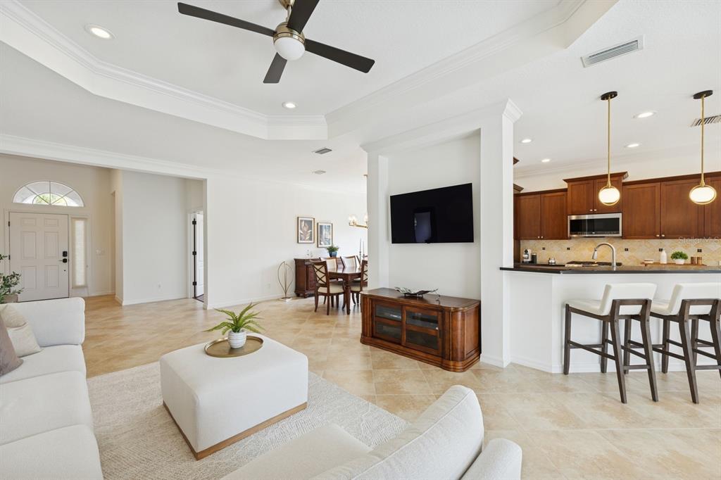 14614 Newtonmore Lane Lakewood Ranch, FL 34202 - Photo 12 of 72 a living room with furniture kitchen view and a flat screen tv