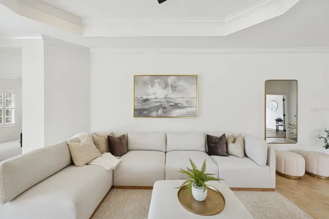 a dining room with wooden floor a chandelier a wooden table and chairs