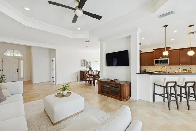a view of a dining room with furniture a chandelier and wooden floor