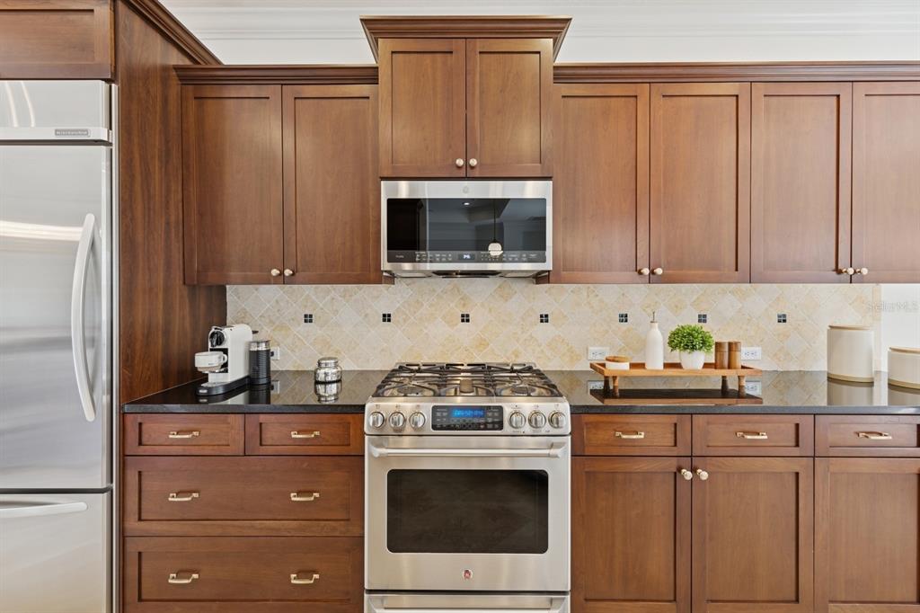14614 Newtonmore Lane Lakewood Ranch, FL 34202 - Photo 14 of 72 a kitchen with granite countertop cabinets stainless steel appliances and a sink